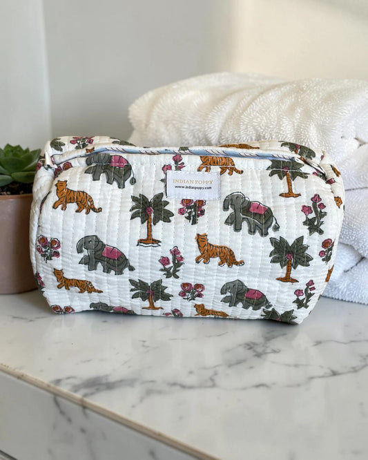 Fun, bright printed wash, toiletry and cosmetics bag displayed on a marble vanity, stylish giftable pouch for beauty essentials and travel accessories